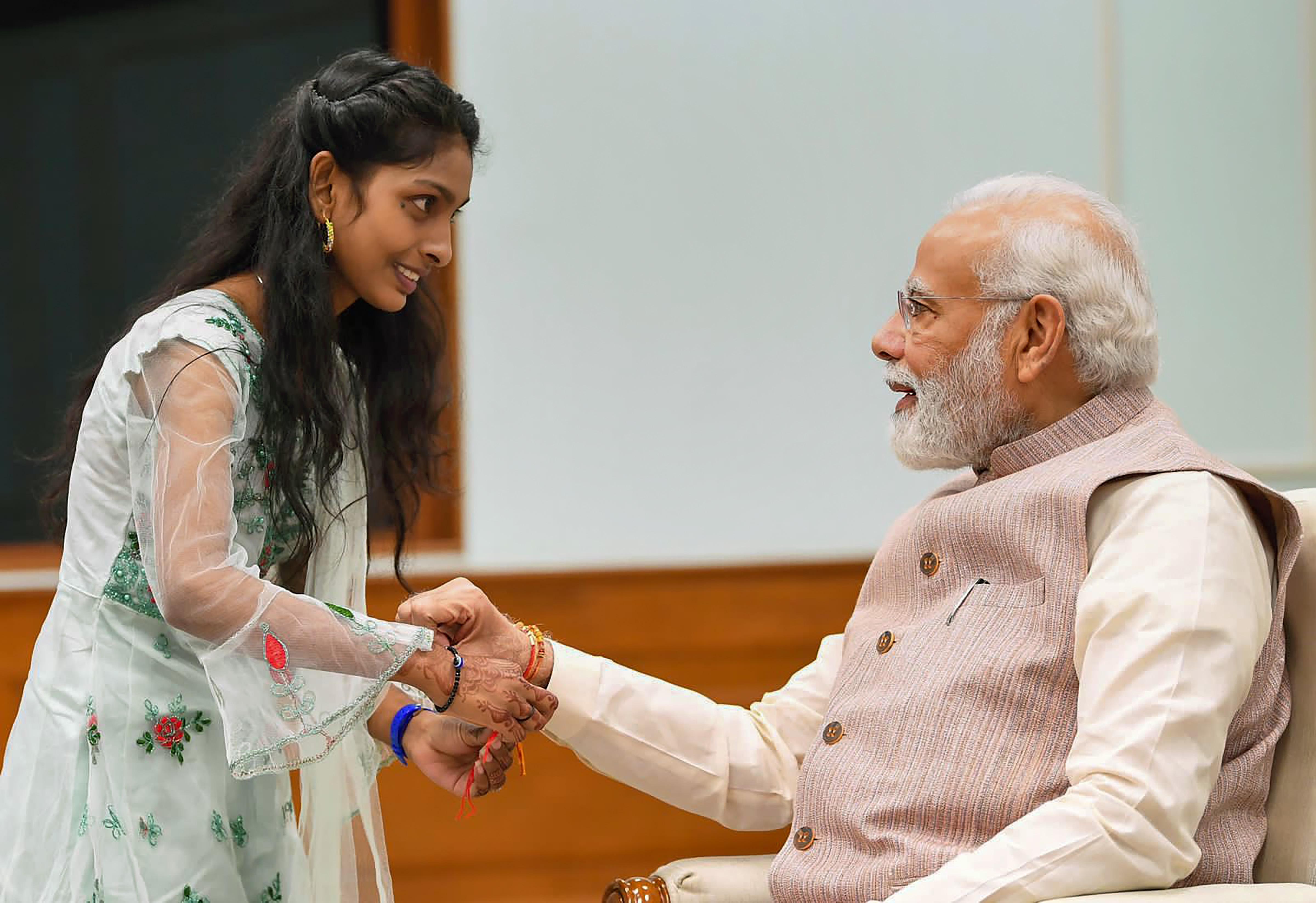 Prime Minister Narendra Modi celebrated Raksha Bandhan with the daughters of staff members working at his office by tying rakhis on his wrist. Pic/PTI