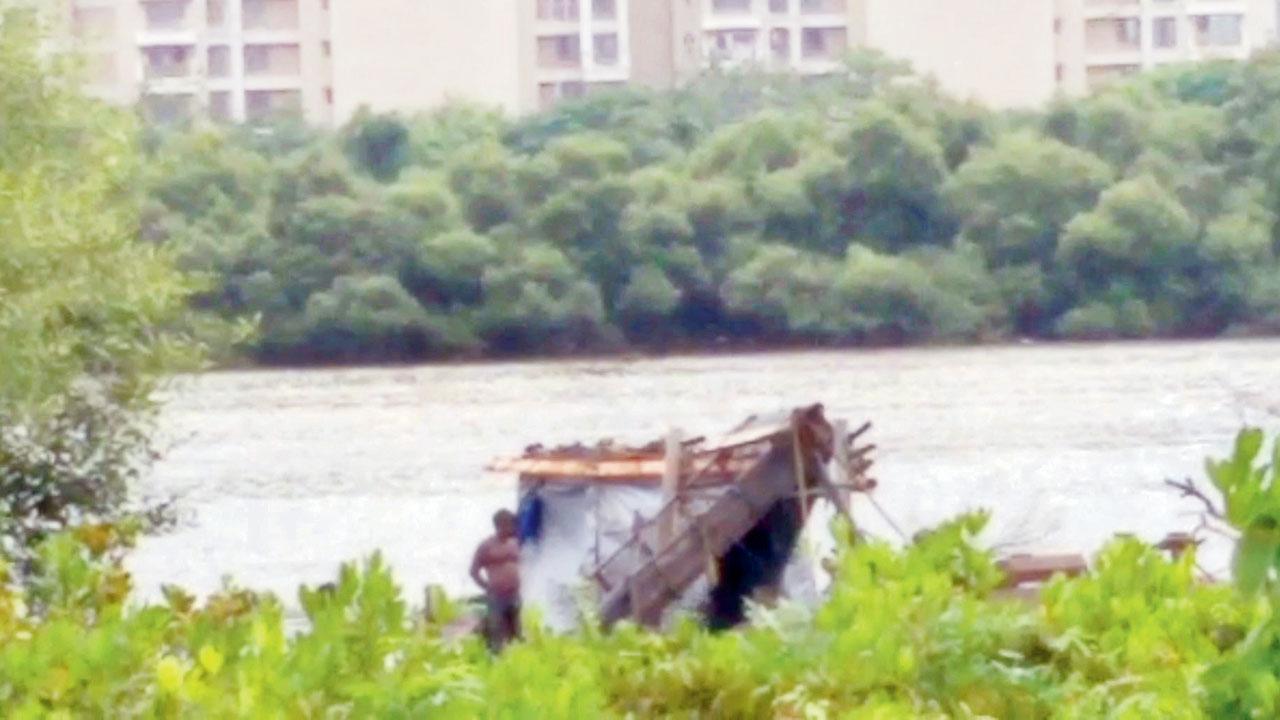 A sand mining site, with residential towers in the background, at Kharghar