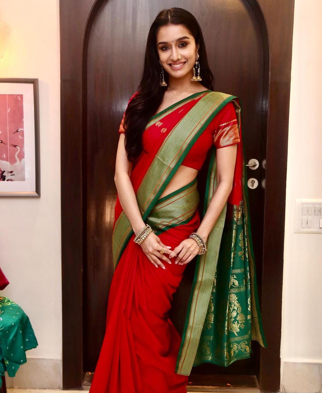 Shraddha looked gorgeous in a red and green traditional saree. She completed her look with traditional jewellery including golden jhumkas, a nose ring, and bangles. She left her hair open and wore a bindi as well