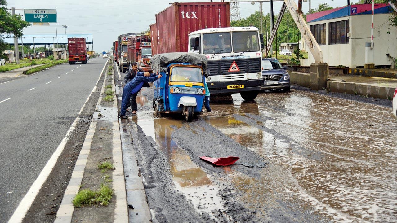 Mumbai-Ahmedabad Highway: A pothole-ridden road near the Gujarat RTO checkpost on Mumbai-Ahmedabad Highway. Pic/Pradeep Dhivar