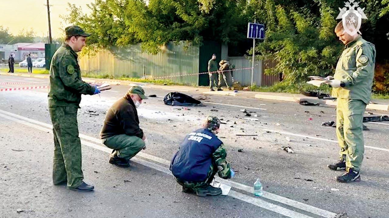 Investigators at the site of explosion of a car driven by Daria Dugina. Pic/AP