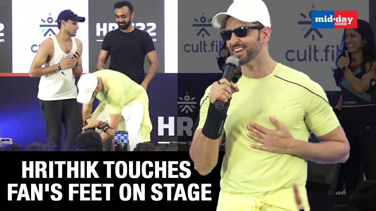 Hrithik Roshan touches his fan's feet at an event