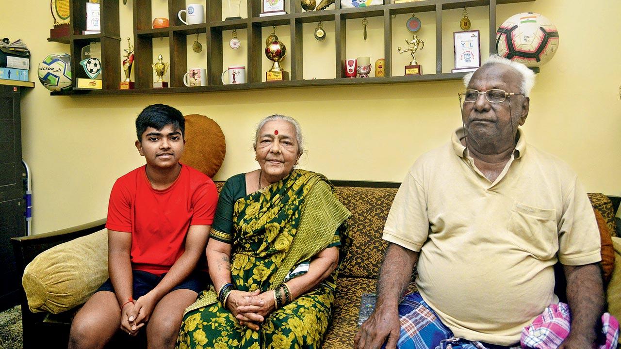 Bhumika Mane, with her grandparents Draupadi and Ganpat Mane, at their Mahim home. The Manes have been supportive of Bhumika’s football dreams