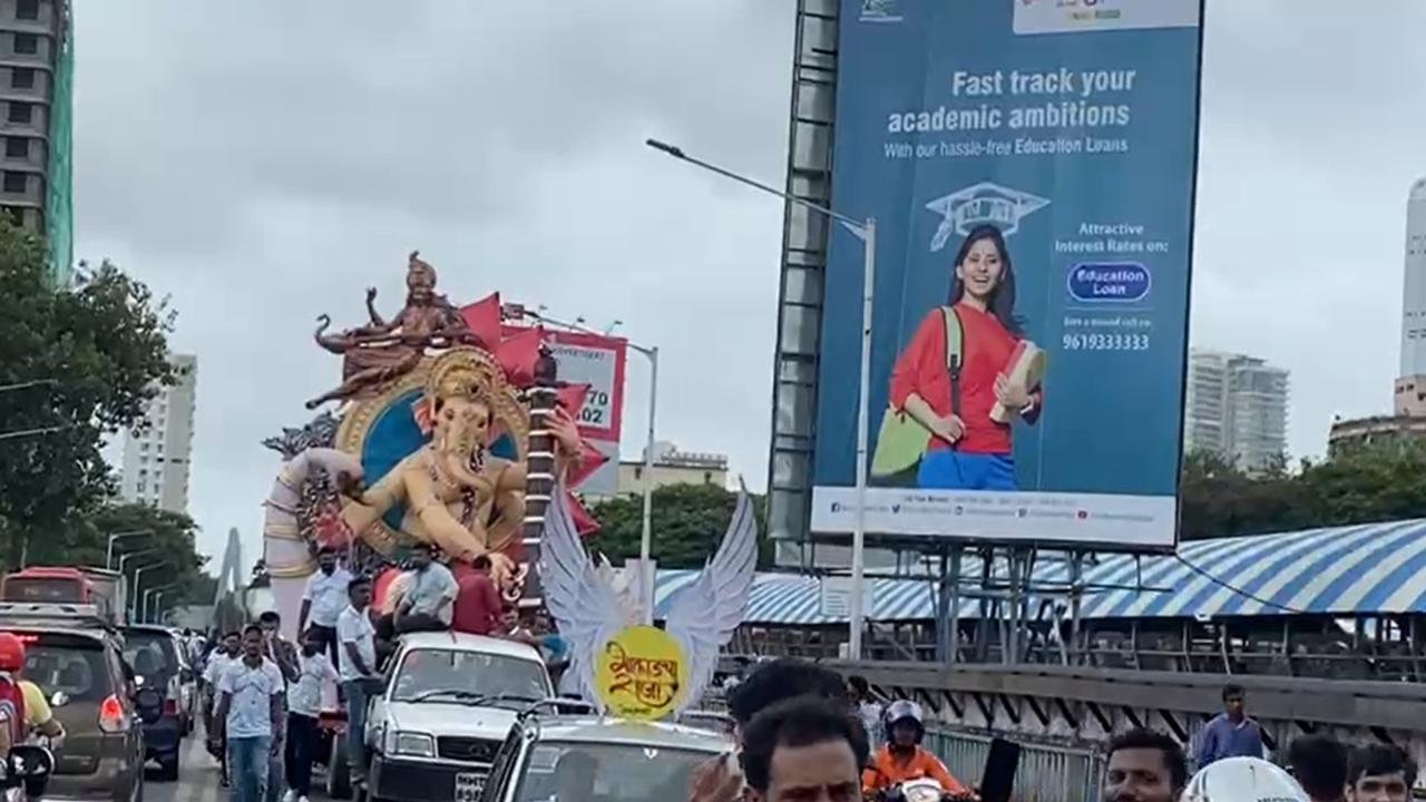  Devotees carry Bappa's idol during a procession in Dadar on Sunday. Pic/Ashish Rane
