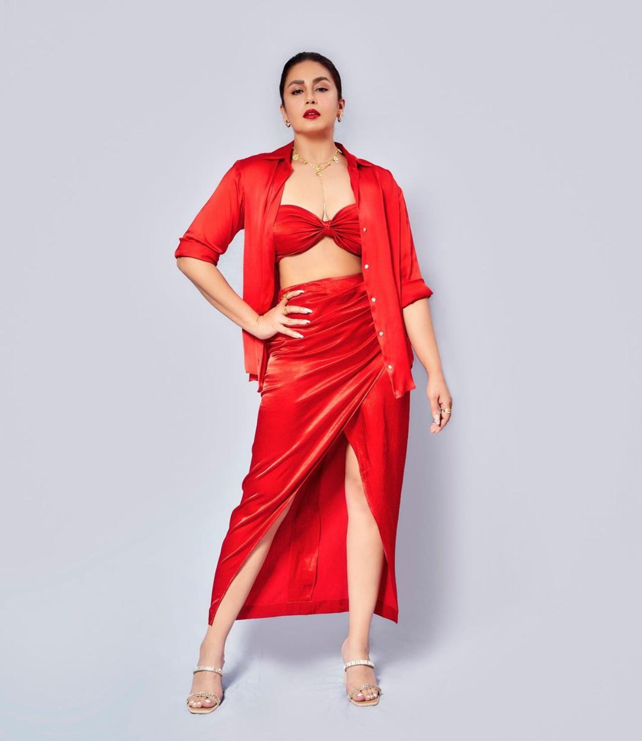 She complimented her look with silver heels and accessorised with multiple finger rings, a pair of statement golden hoops and golden chain. She opted for a natural makeup look to go with her bright outfit. Huma picked a pair of silver heels from Cai's racks to go with her all-red outfit