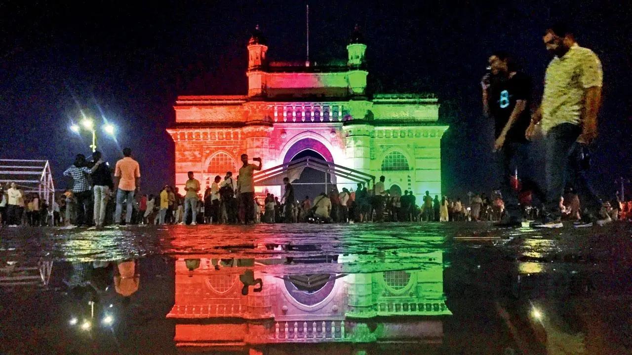 The tricolour sheen: The Gateway of India looks resplendent in the colours of the Indian National Flag as people gather around it to click photographs. Pic/Ashish Raje
