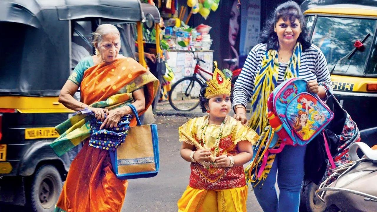 Krishna in a traffic Jam: With the city getting into the mood to celebrate Janmashthami, a student dressed up as lord Krishna, crosses the road at Patkar Nagar in Dombivli. Pic/Satej Shinde