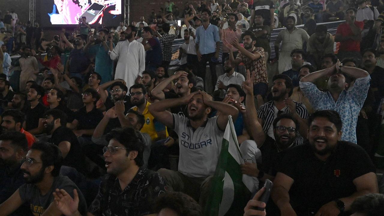 Cricket fans in Lahore react to a moment from the high-octane clash between arch-rivals India and Pakistan. Photo/AFP