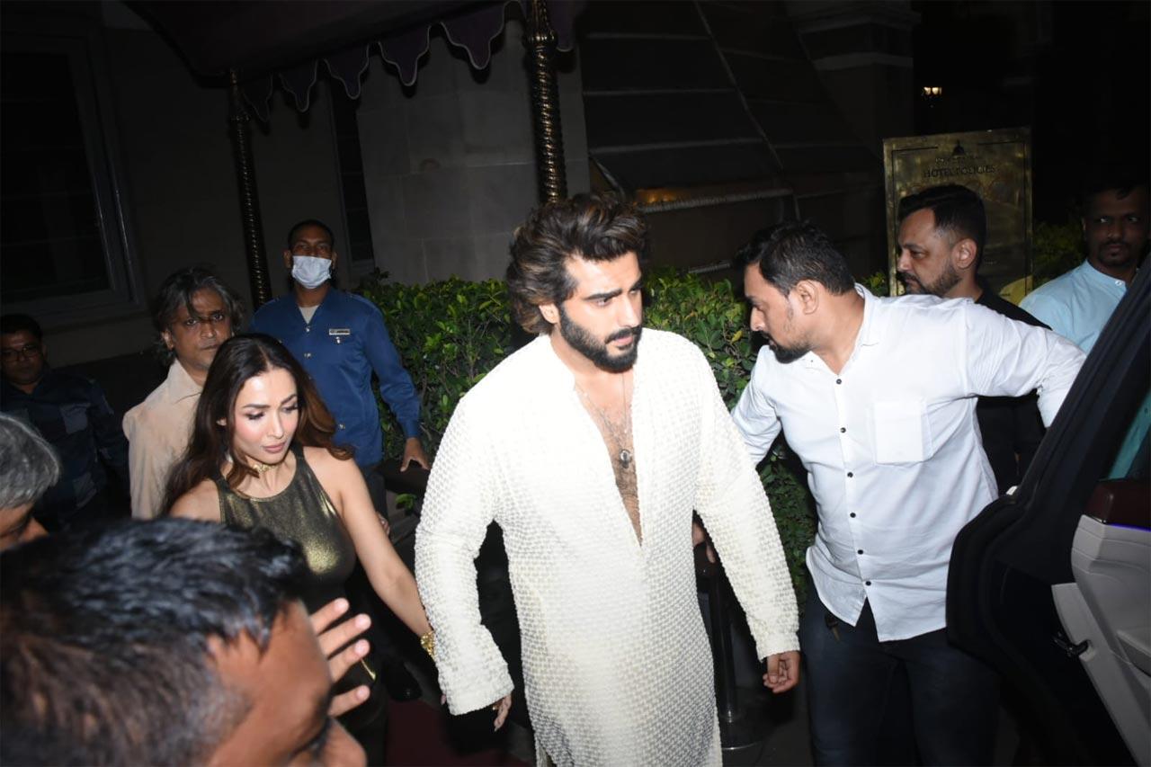 Arjun Kapoor stayed true to the theme and was seen wearing a white-coloured sherwani for Kunal Rawal and Arpita Mehta's wedding. Malaika Arora was seen wearing a metallic co-ord set as she stepped out of the wedding venue