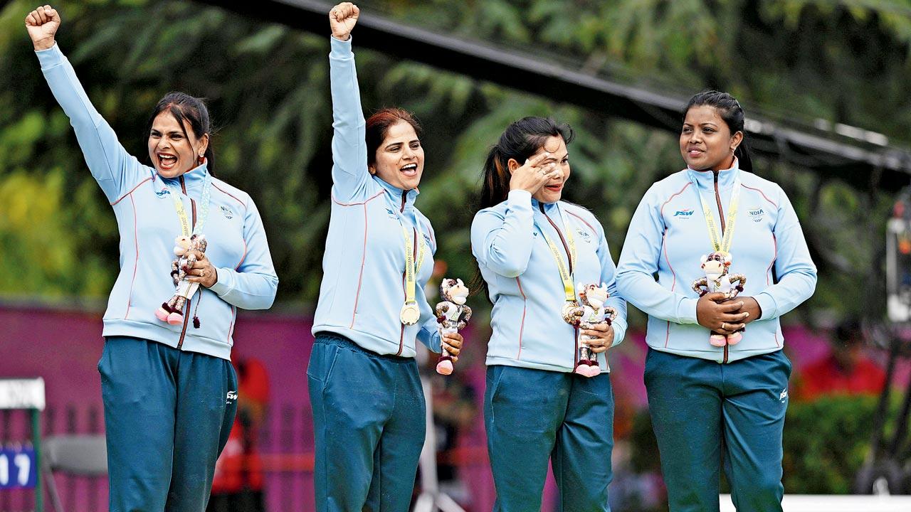 India’s Lovely Choubey (extreme left), Pinki, an emotional Nayanmoni Saikia and Rupa Rani Tirkey (extreme right) on the podium with their lawn bowls fours gold. Pic/Getty Images