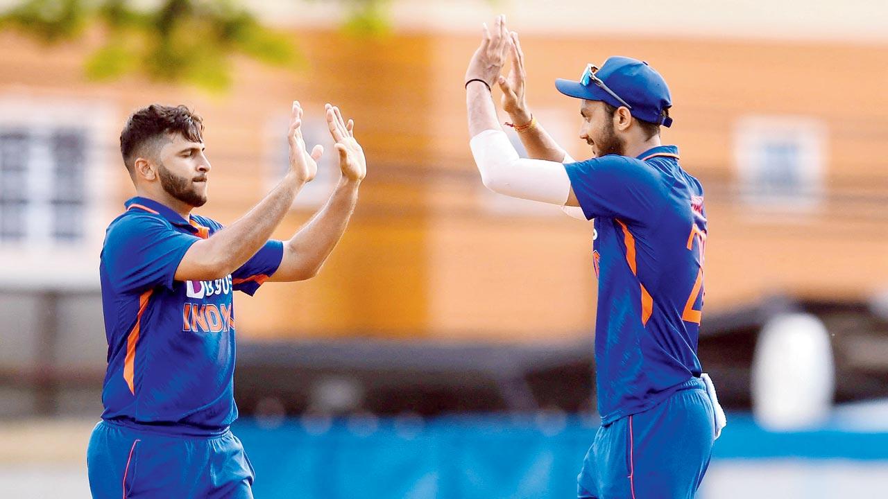 Shardul Thakur (left) celebrates a wicket with Axar Patel on Saturday. Pic/ICC