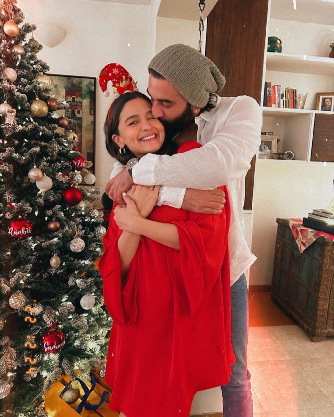 In one of the pictures, actor Ranbir Kapoor could be seen giving a warm back hug to his wife Alia and kissing her on her cheeks as she can't stop smiling. In the picture, Alia donned a red top with a Santa hat whereas the 'Besharam' actor opted for a white shirt with an olive green beanie cap