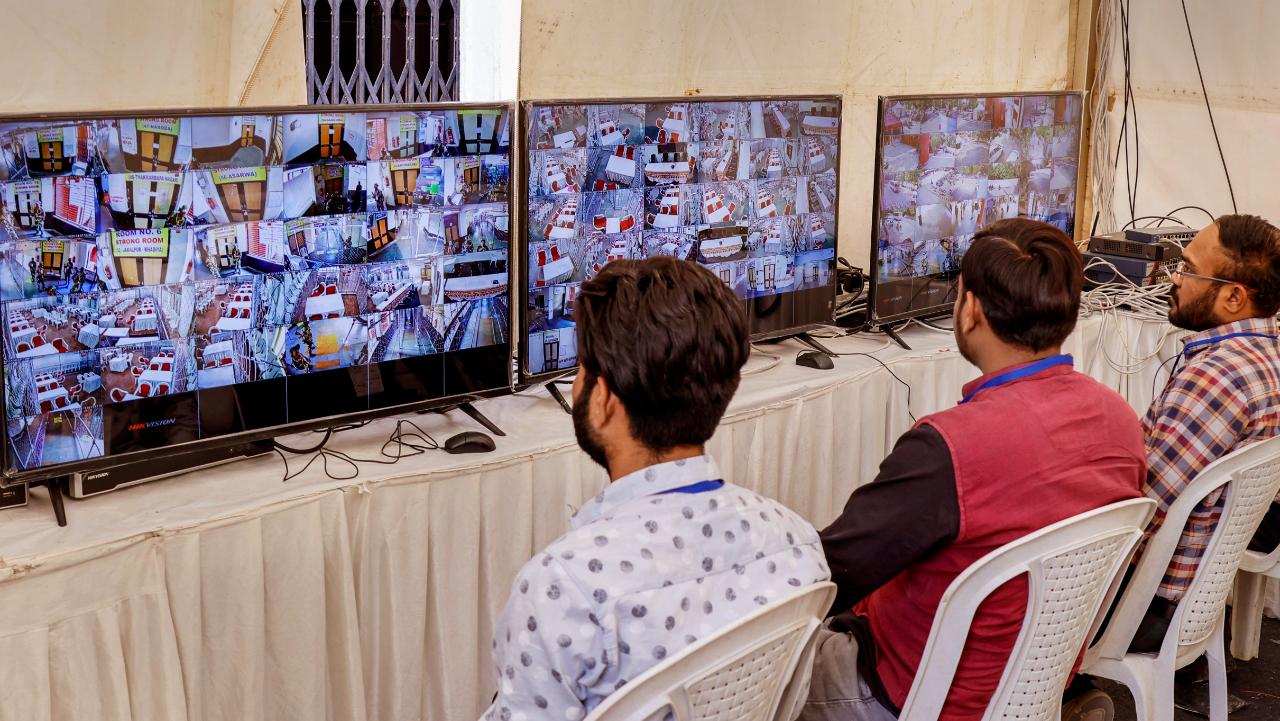 Polling officials monitor strong room through CCTV footage ahead of counting for the Gujarat Assembly elections, in Ahmedabad