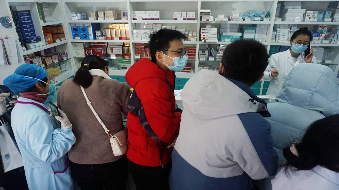 People stand in queue to buy antigen test kits at a pharmacy in Hangzhou, China.