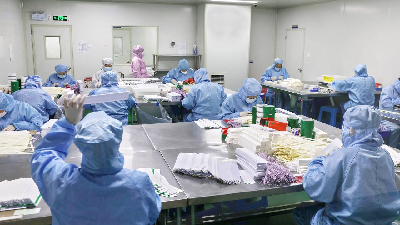 Workers produce antigen test kits for the Covid-19 coronavirus at a factory in Nantong, in China's eastern Jiangsu province.