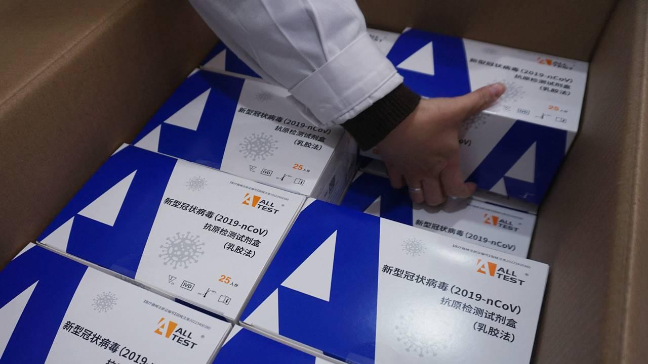 A staff member prepares antigen test kits at a pharmacy amid the Covid-19 pandemic in Hangzhou, in China's eastern Zhejiang province.