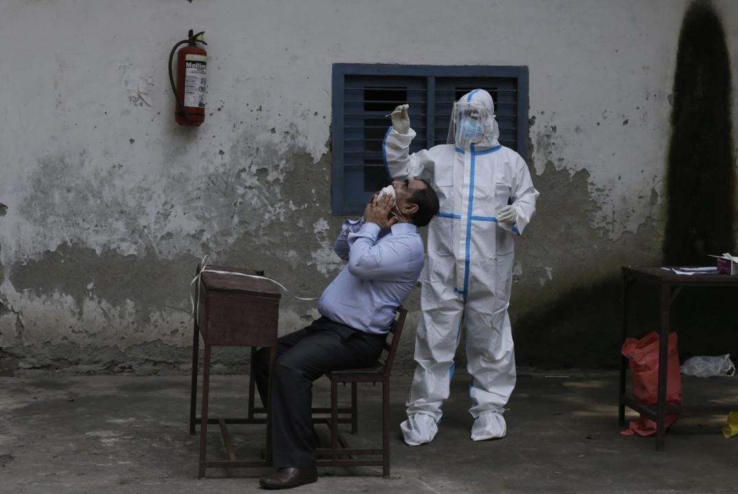 A health worker collects a swab sample for Covid-19 test. File Pic