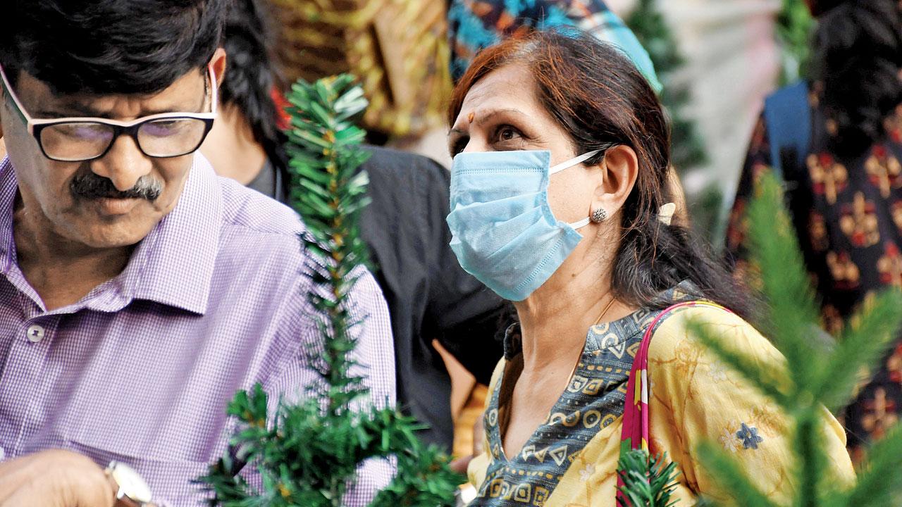 A woman wearing a mask shops at Lohar Chawl, near Crawford market. Pic/Ashish Raje