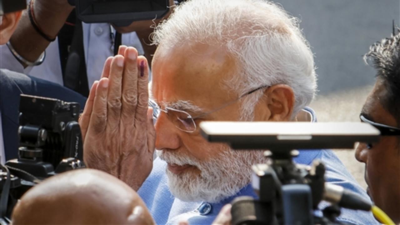 PM Narendra Modi speaks with media after casting his vote at a polling booth Pic/PTI