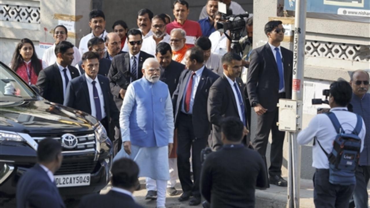 Prime Minister Narendra Modi arrives to cast his vote at a polling booth