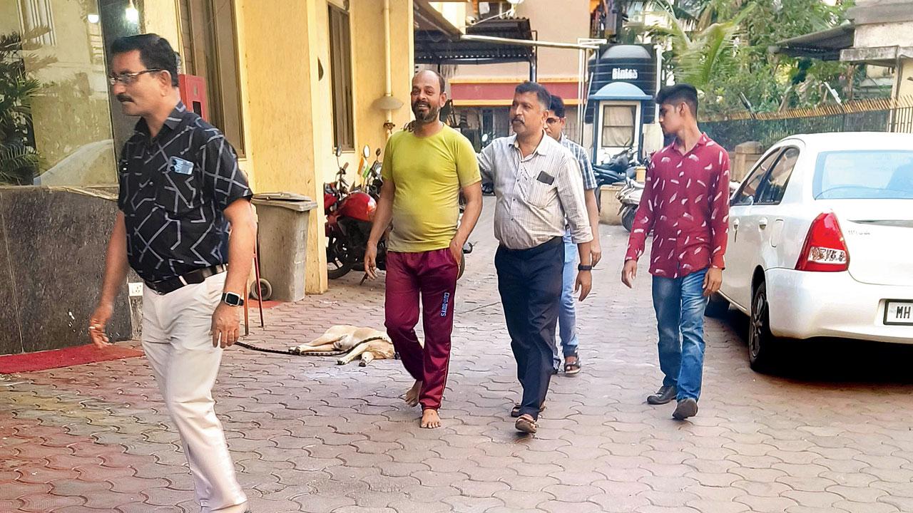 Chand Aziz Khan (green T-shirt), who helped Dubey escape last week, with Vasai cops on Wednesday