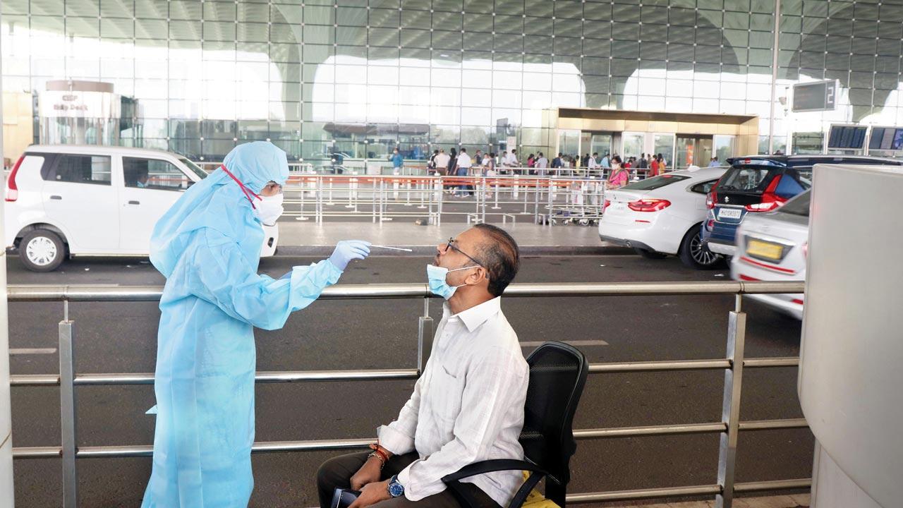 A passenger gets tested for COVID-19 at Mumbai airport in November 2020. File pic