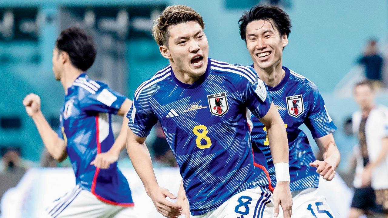 Japan’s Ritsu Doan (centre) celebrates with teammate after scoring the equaliser v Germany. Pic/Getty Images