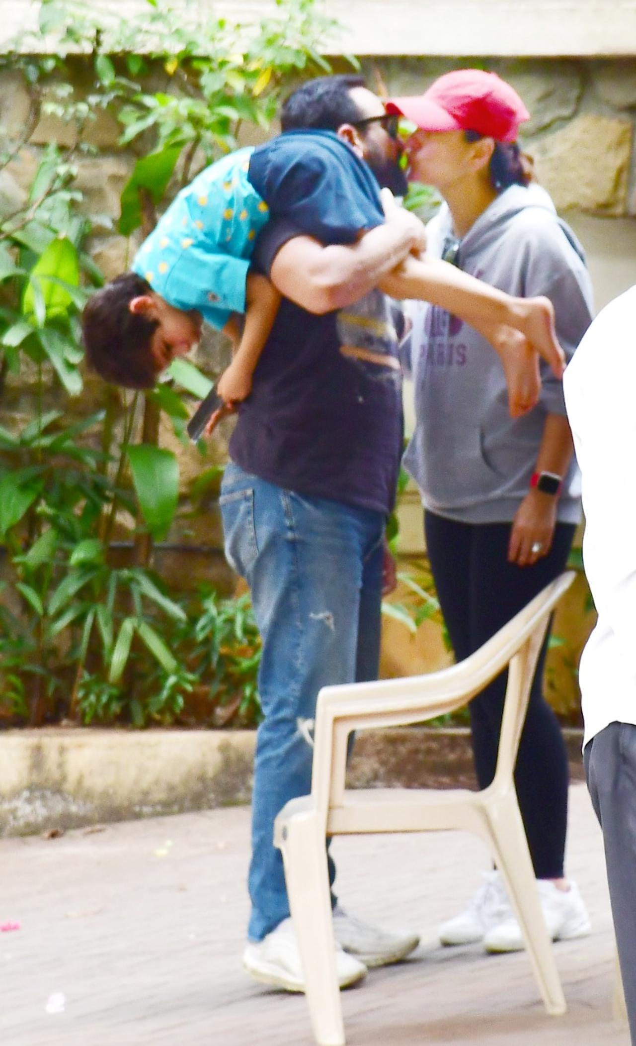 Meanwhile, Saif and Kareena were captured by the paparazzi having a PDA moment. However, it was Taimur who stole the limelight with him being lodged on Saif's shoulder and being immersed in his phone