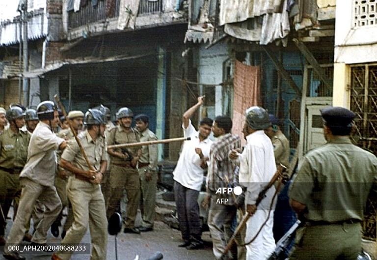 Indian police clash with rioters in Ahmedabad on April 5, 2002
