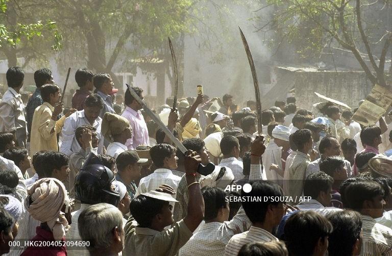 This picture, taken on March 1, 2002, shows a mob waving swords at an opposing mob during communal riots in Ahmedabad