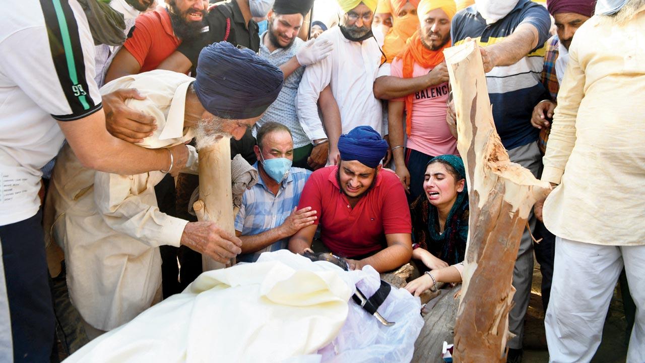 Prabhjot Singh (centre) along with his family members cry over the body of Satnam Singh who was killed in Galwan, in Punjab on June 18. Pic/AFP