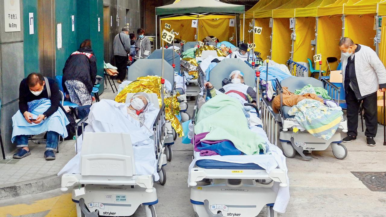 People lie in hospital beds outside Caritas Medical Centre in Hong Kong on Tuesday. Pic/AFP