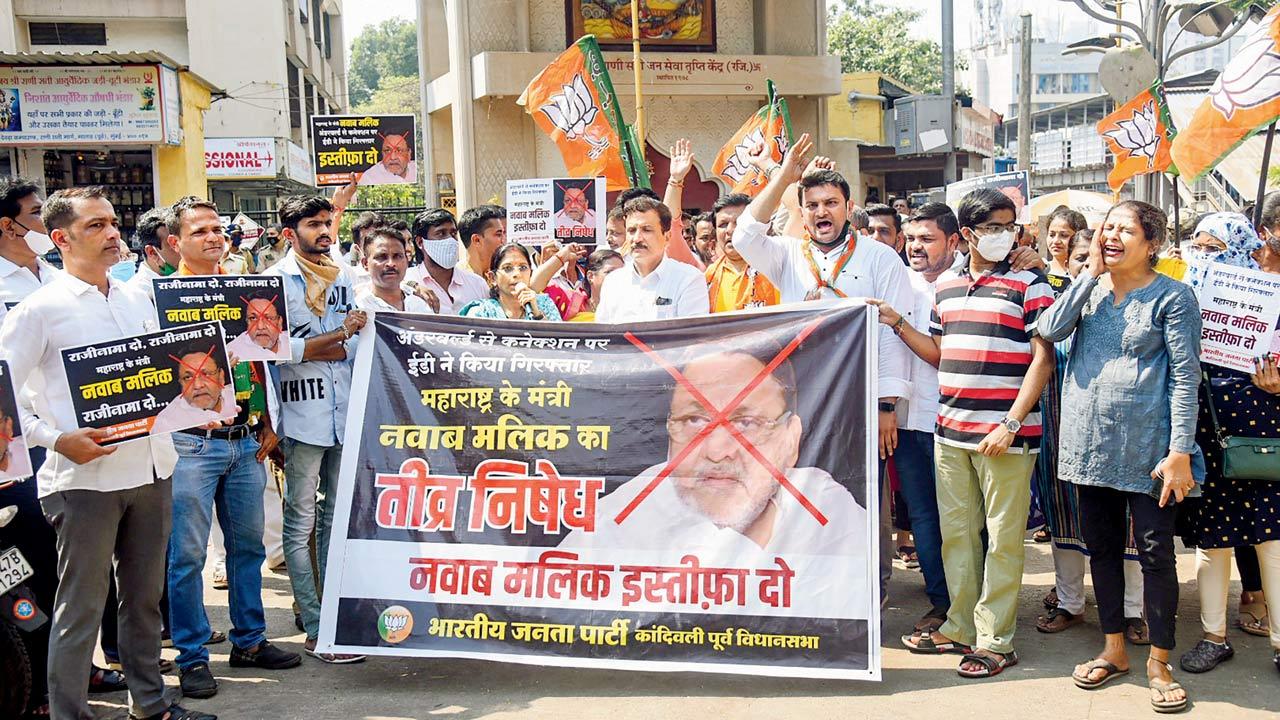 BJP workers stage a protest, demanding Malik`s resignation, on Thursday. Pic/PTI