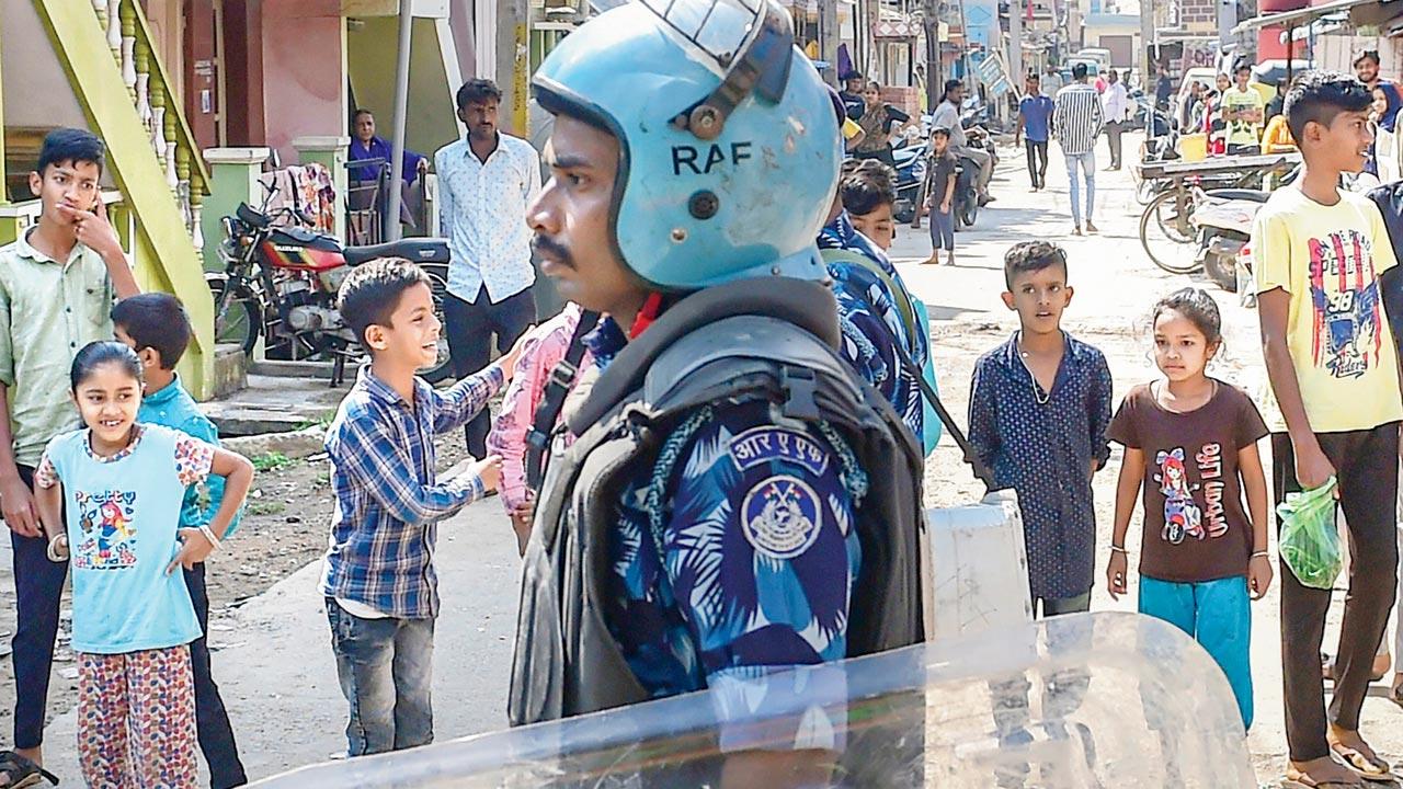 A security personnel on a street in Shivamogga on Tuesday. Pic/PTI     
