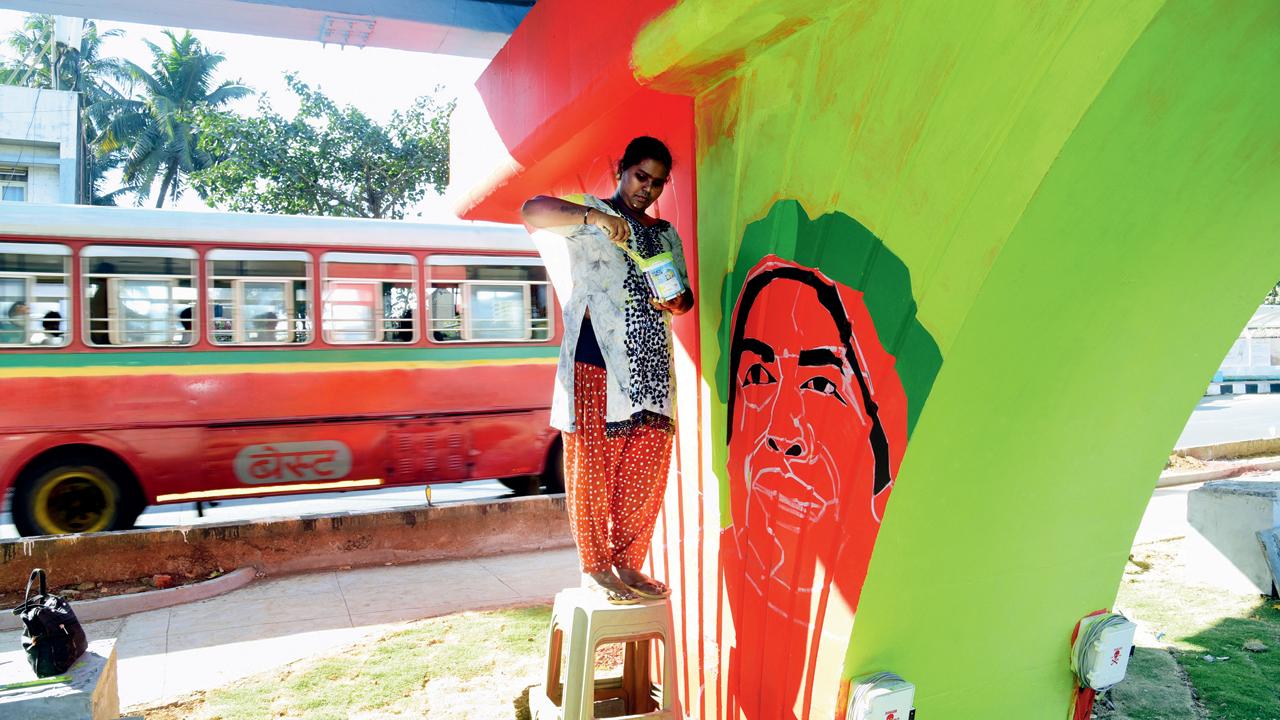 Artist Deepa paints a pillar green