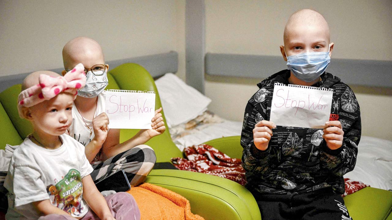 A pediatrics hospital move their beds to the basement which is being used as a bomb shelter, in Kyiv on Monday. Pic/AP