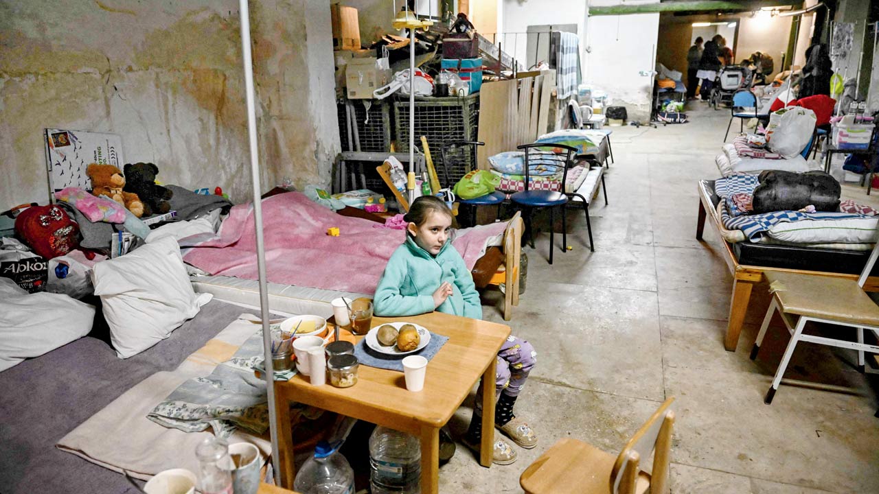 Children struggling with cancer hold signs that read ‘Stop War’, in the bomb shelter of an oncology centre in Kyiv, on Monday. Pic/AFP