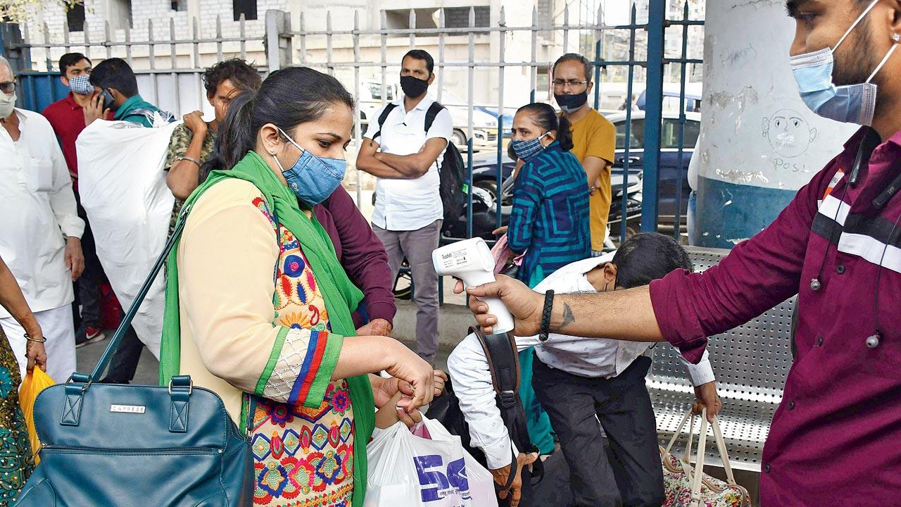 A passenger’s temperature is checked at Dadar station on Wednesday. Pic/Ashish Raje