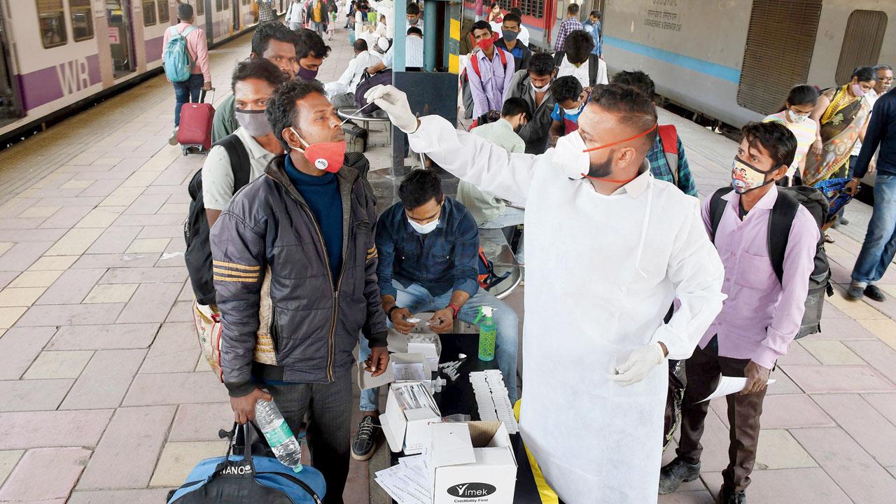 A BMC worker collects a swab sample at Dadar station, on February 17. Pic/Ashish Raje