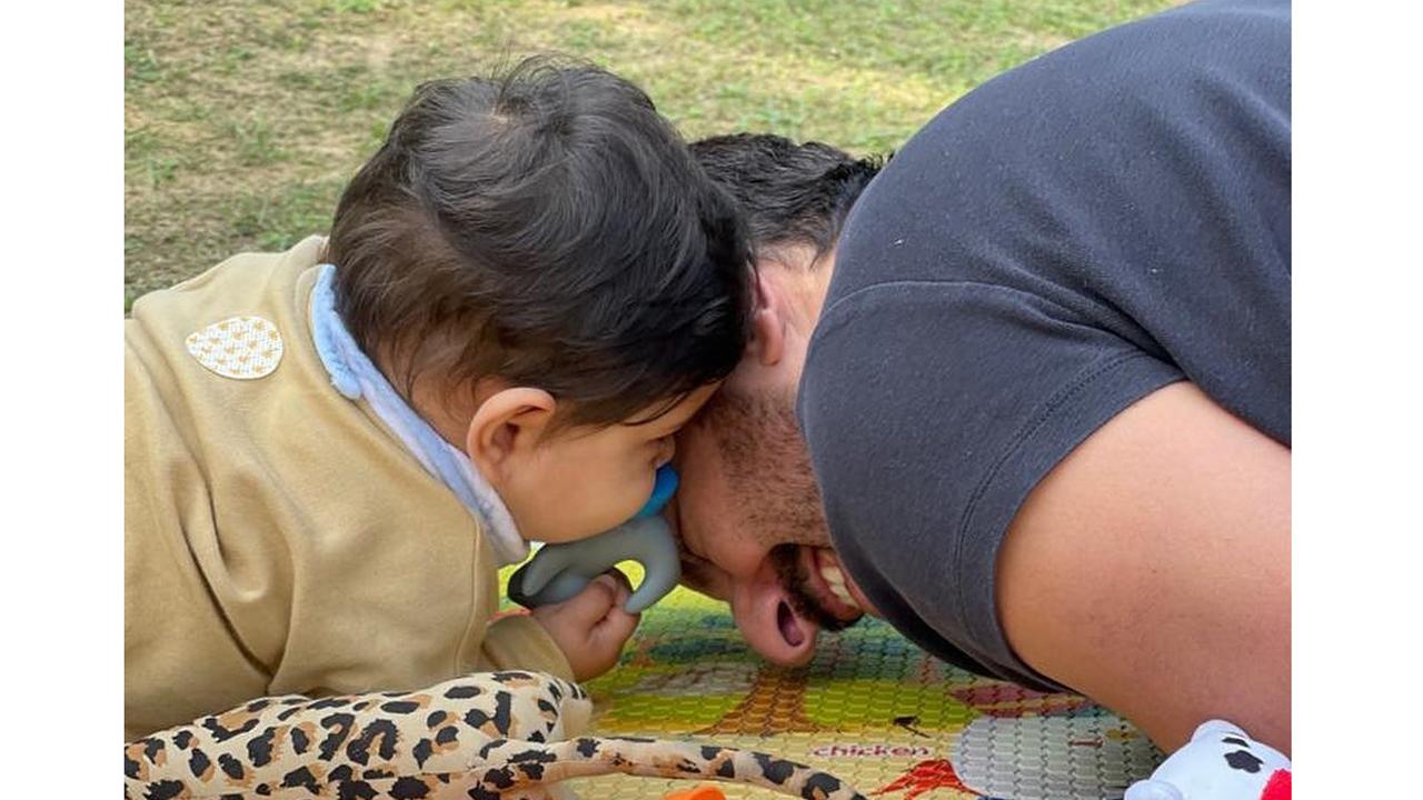 Dad and baby bond at a picnic on a beautiful sunny day. Isn't this the cutest picture!