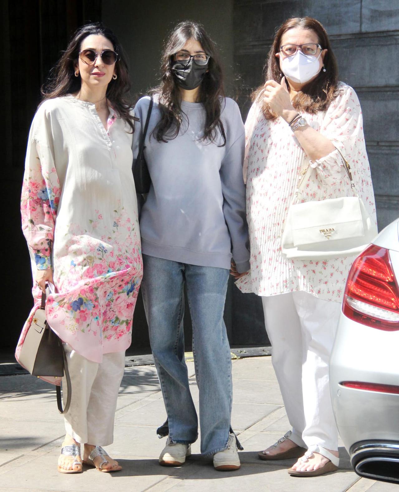 Karisma Kapoor posed with her daughter Samaira and mother Babita as they arrived at Randhir Kapoor's birthday bash in the city.