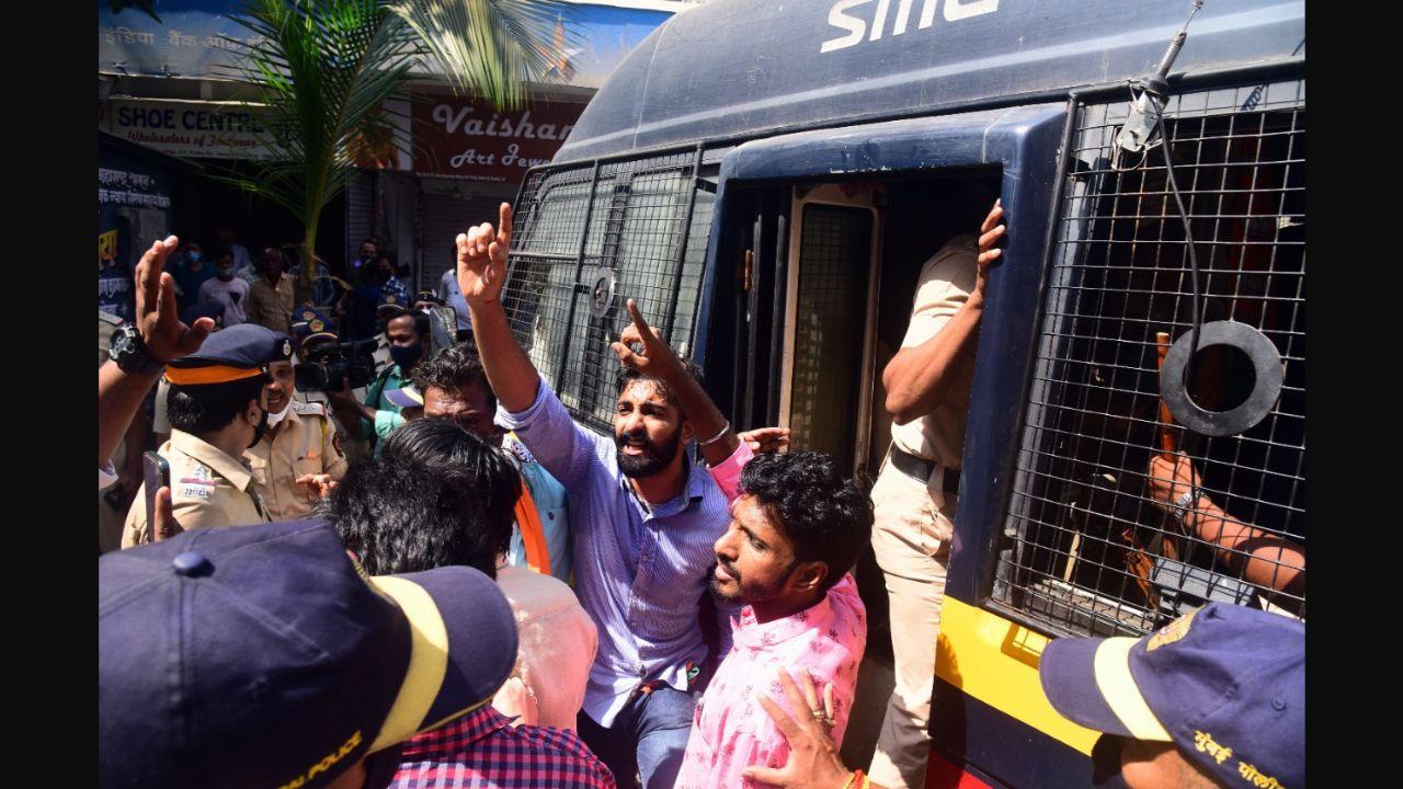 Mumbai Police detaining a protestor outside BJP's office in Dadar