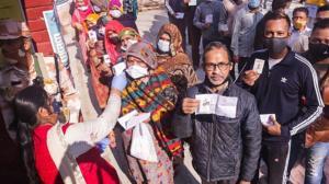 People wait to cast votes for Punjab Assembly elections at a polling station in Patiala on Sunday. Pic PTI