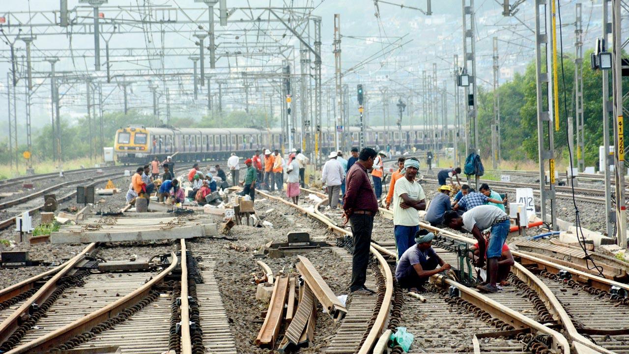 Workers carry out infra work on the new lines near Thane station. File pic
