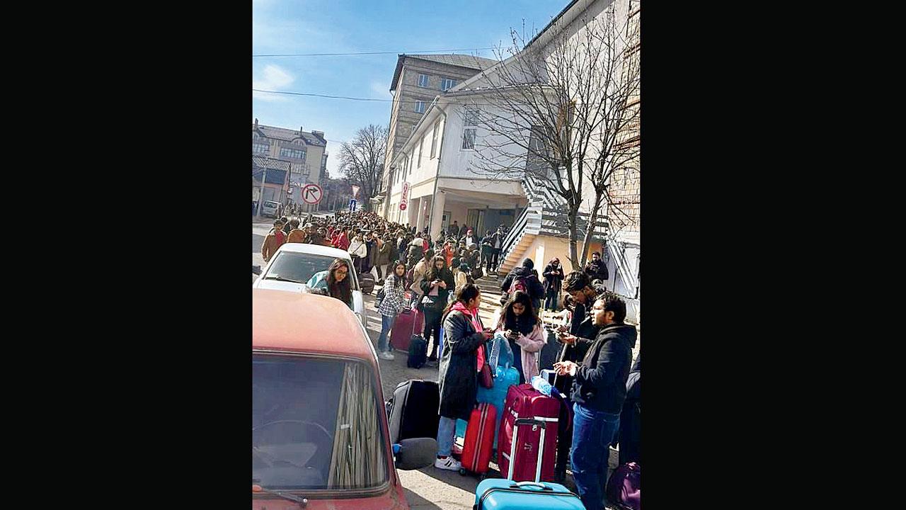 Indian students wait in queues to leave for Romania border, outside their hostel in Ivano-Frankivsk city of Ukraine, on Saturday 