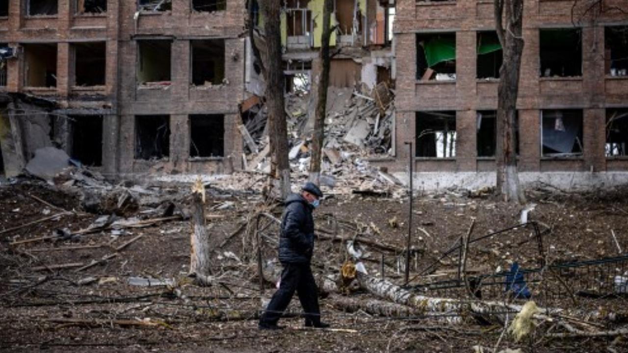 A man walks in front of a destroyed building after a Russian missile attack in the town of Vasylkiv, near Kyiv, on February 27. Pic/AFP