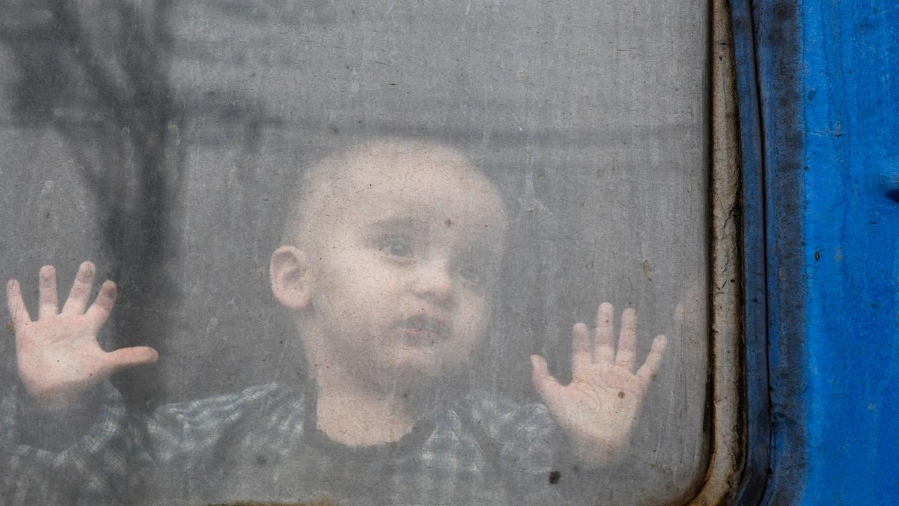 A child watches from a train carriage waiting to leave for western Ukraine at the railway station in Kramatorsk, eastern Ukraine. Pic/PTI