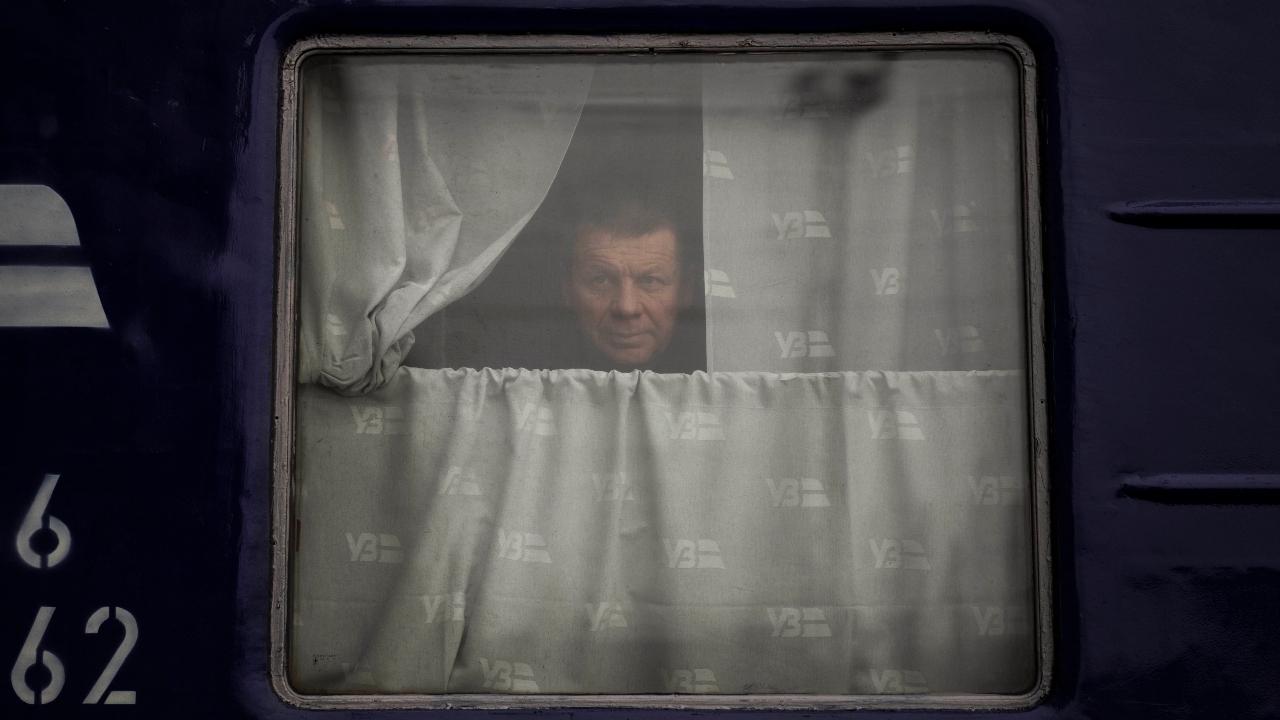 A man looks out of the Dnipro-Truskavets train, at the Lviv railway station, Sunday, Feb. 27, 2022, in Lviv, west Ukraine. The U.N. has estimated the conflict could produce as many as 4 million refugees. Pic/PTI