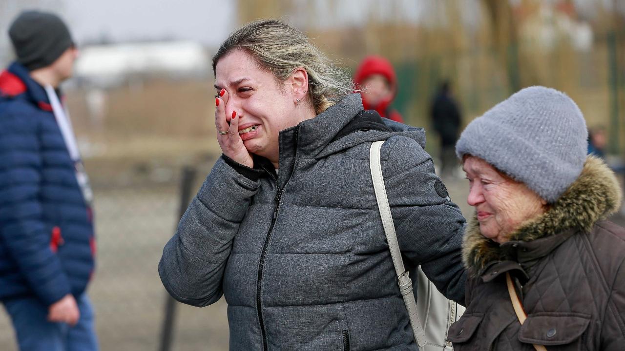 A Ukrainian woman reacts after arriving at the Medyka border crossing, in Poland. Pic/PTI