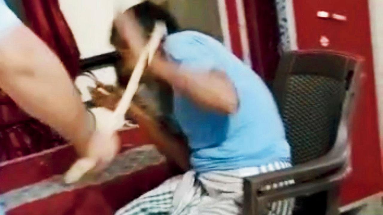Another grab from the video where the man is seen thrashing Abdul Sheikh